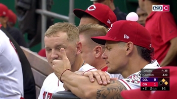 Derek Dietrich can't figure out who put bubble gum on his hat
