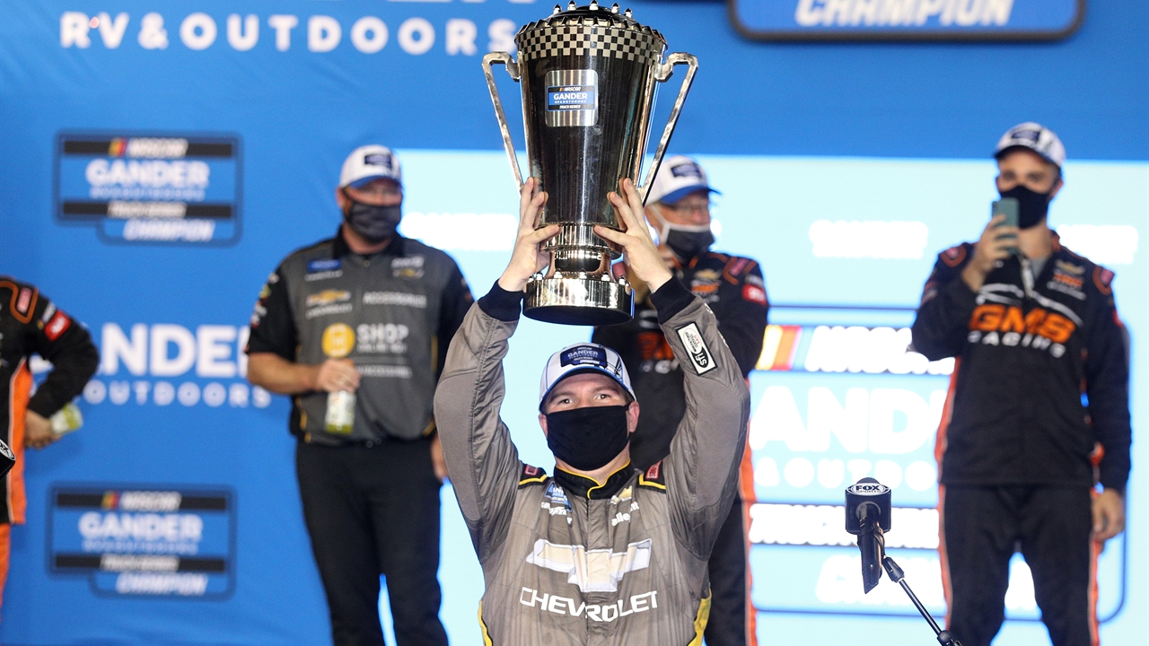 Steve Phelps presents the Gander Outdoor Truck Series Championship trophy to Sheldon Creed