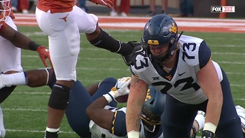 A Texas player got his shoe stuck in a West Virginia player's helmet, and it was hilarious