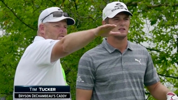 Bryson DeChambeau works through a shot with his caddie ...